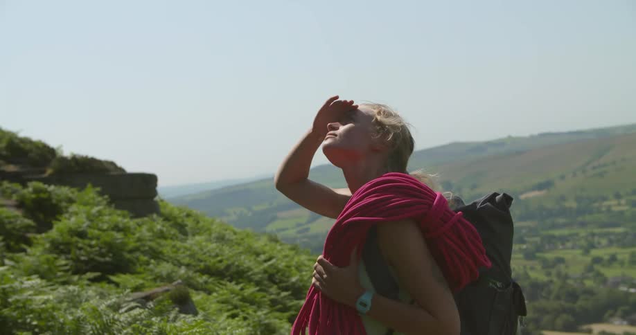A woman is carrying a climbing rope