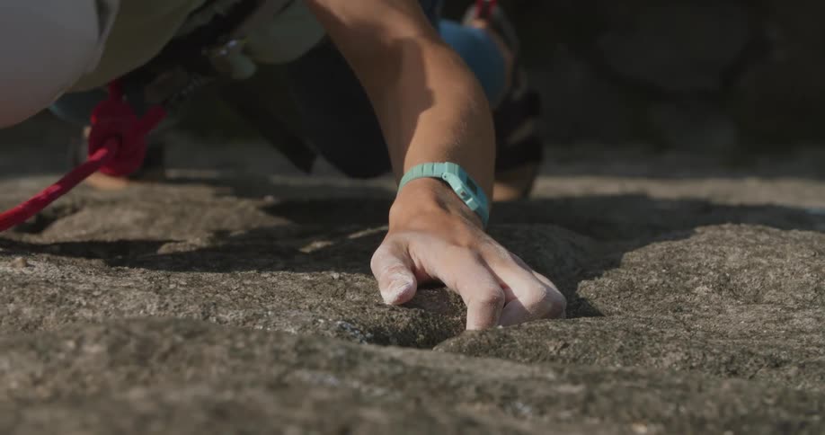 A person is rock climbing up a mountain