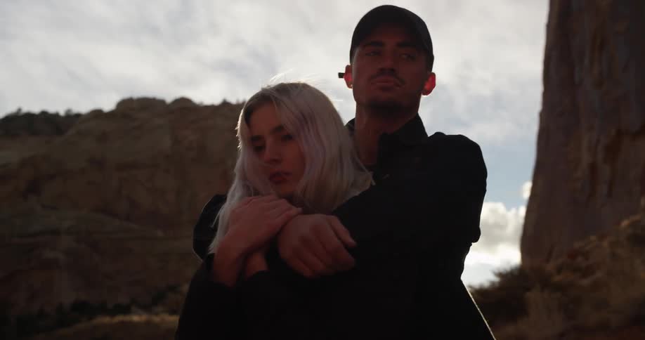 A man is hugging a woman near a canyon