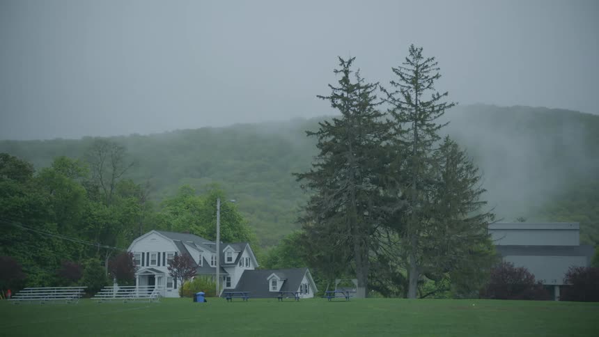 A large home with bleachers on a foggy day