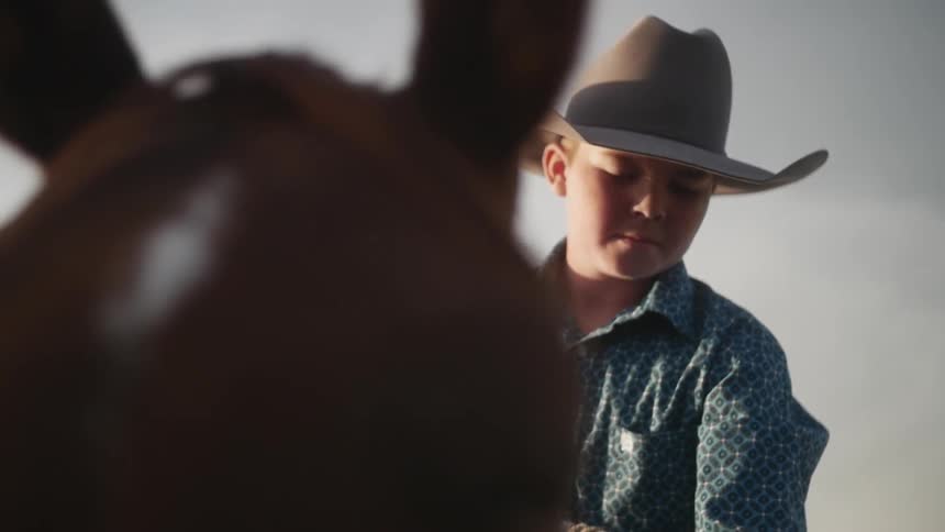 A boy is riding on a horse