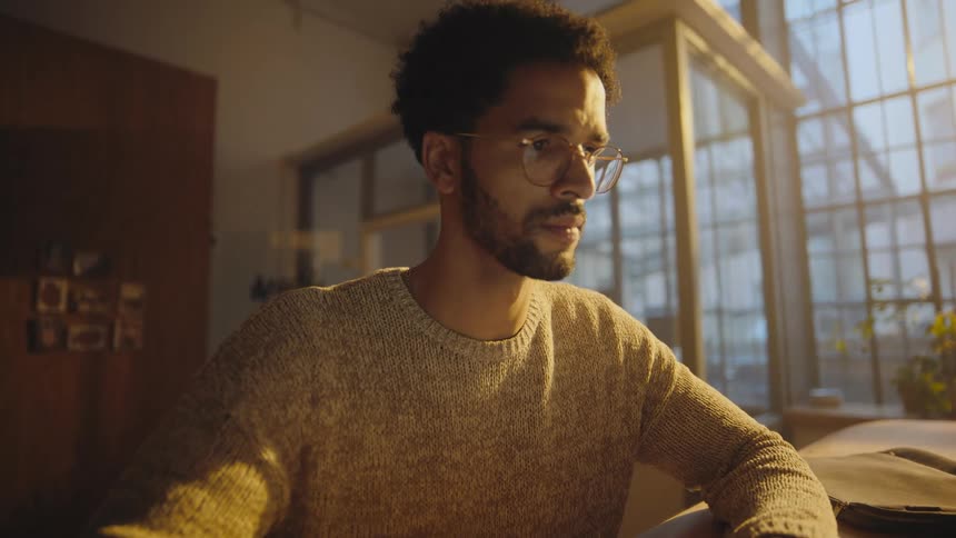 man opens laptop and starts working