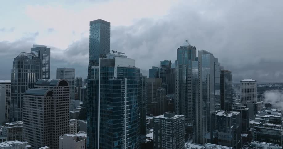 Steam rises from snow covered downtown buildings on a cold winter morning