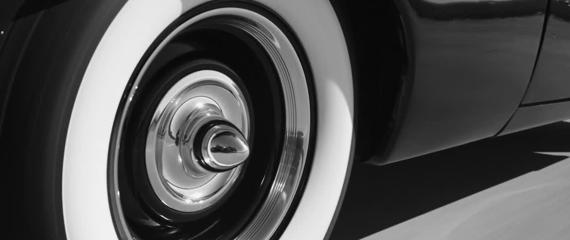 A black vehicle is driving on the road