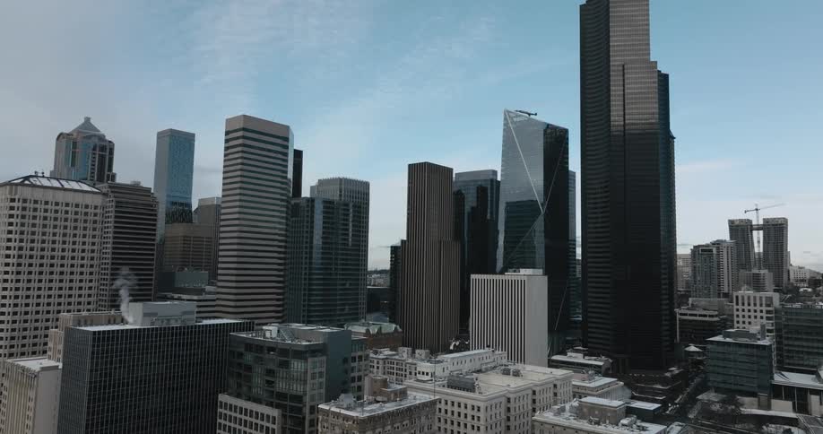 Light snow covers the rooftops of downtown buildings on a cold and crisp winter day