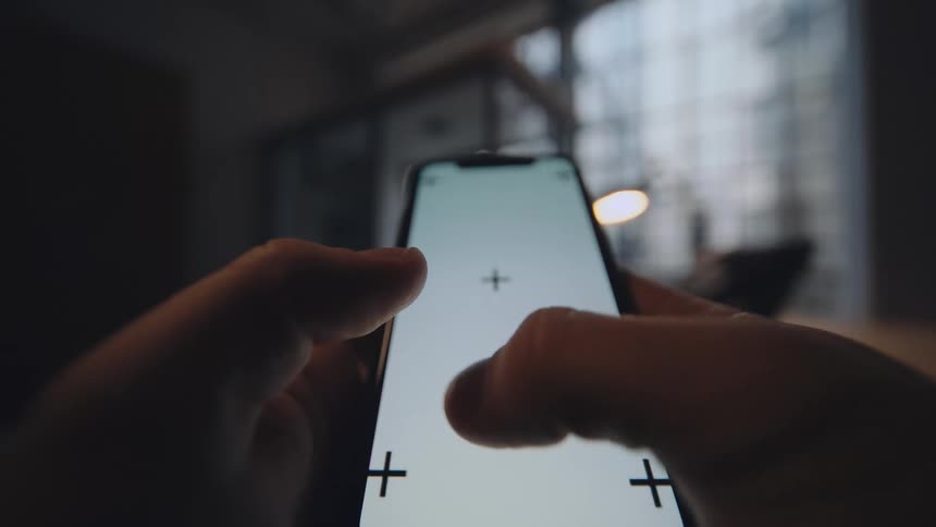pov of hands scrolling on replaceable smartphone screen with tracking markers