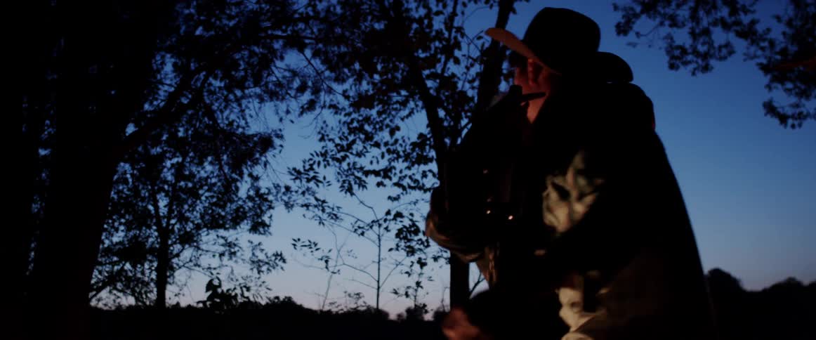 A couple dance and drink in the woods