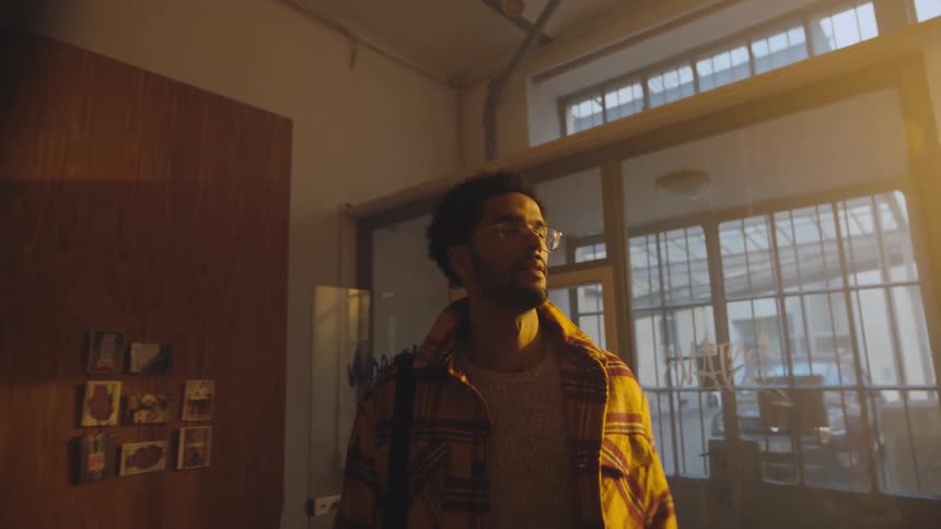 A man enters the home and smiles