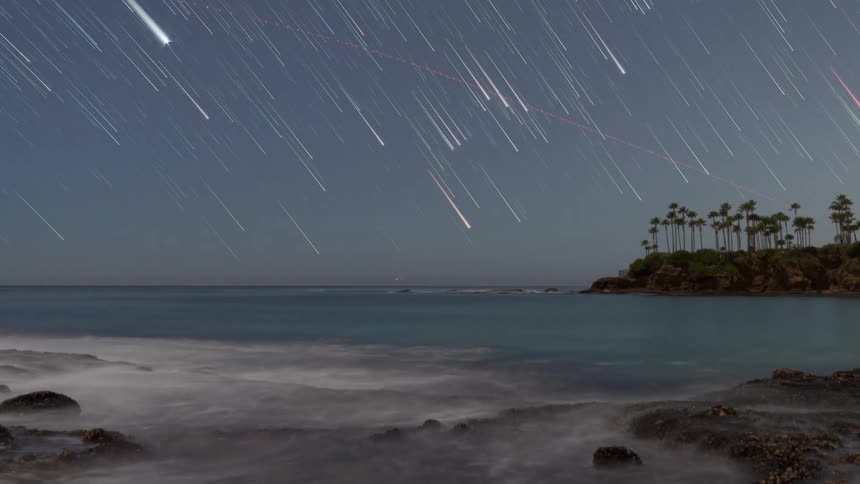 The stars are shooting in the sky by the shore