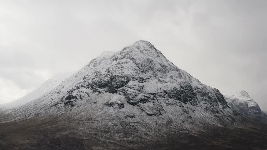 Snow covered mountain under a cloudy sky
