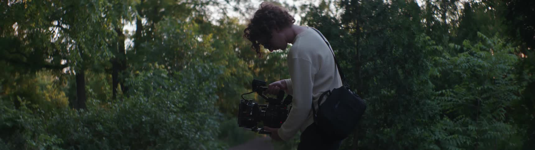 A man standing outdoors filming