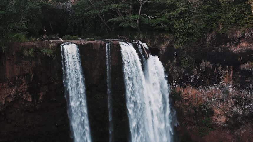 A working waterfall is in the wilderness