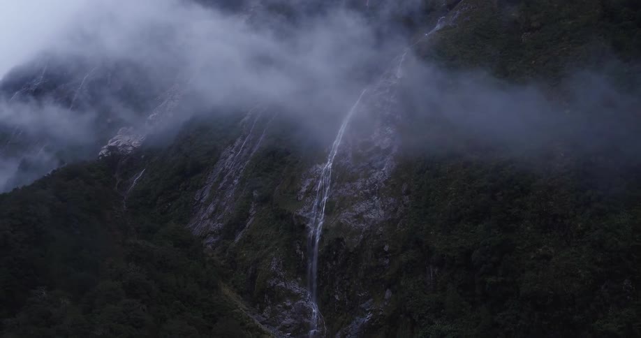 Aerial view of a mountain with a waterfall on it's side