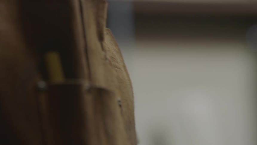 Close-up of a man's apron  in a workshop while he's wearing it