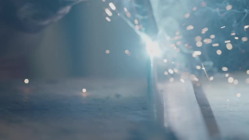 A person is welding metal with a torch