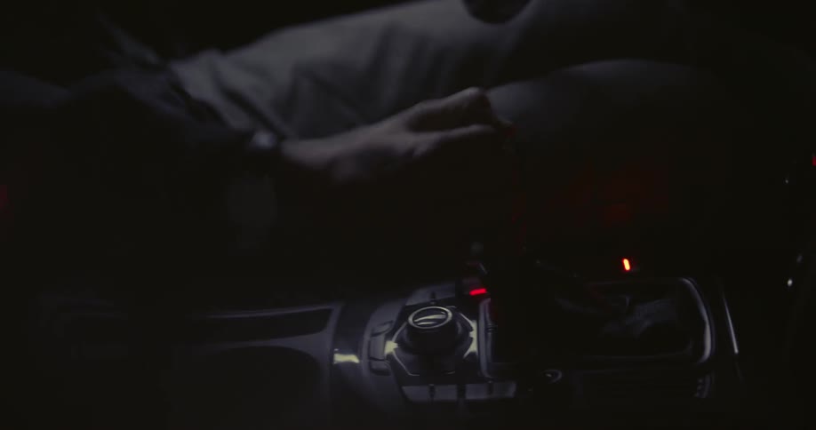 A person is operating a vehicle in the dark