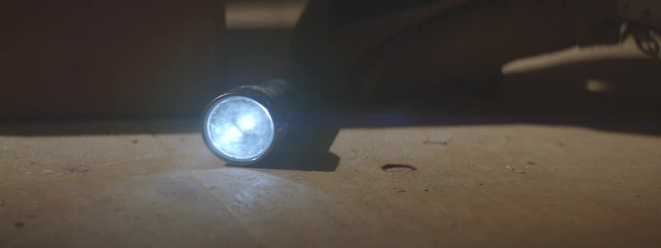 A person setting down a flashlight