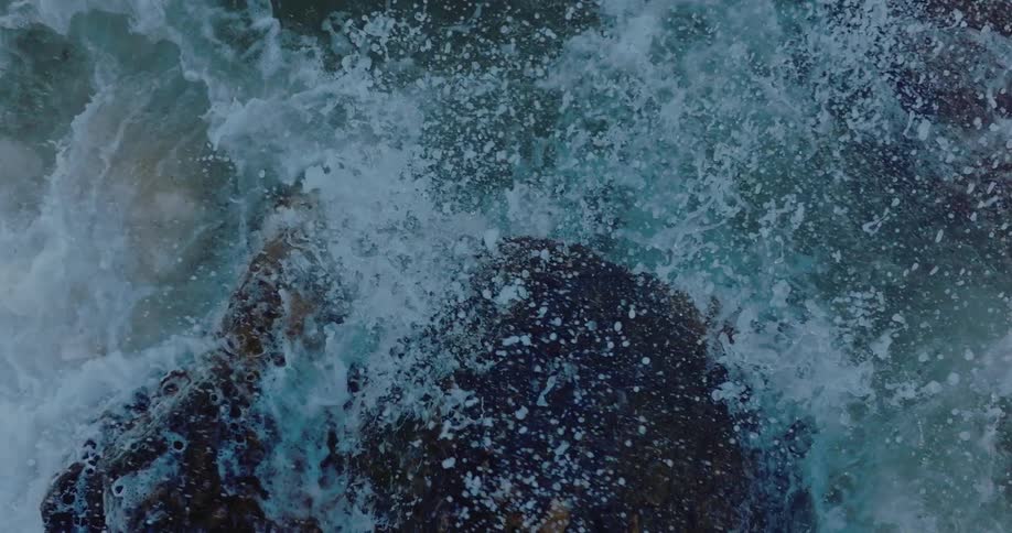 Large waves crash onto rocks in the ocean
