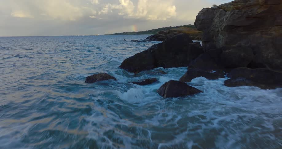 Waves wash onto rocks and sand on the beach