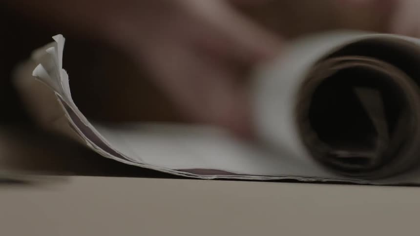 Person unrolling blueprints