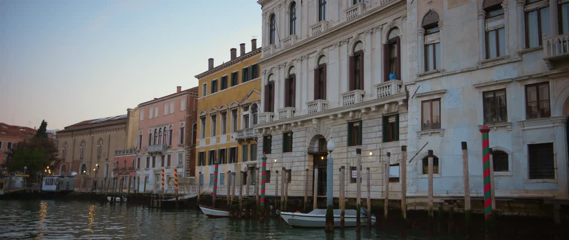 POV floating down the Grand Canal in Venice past various palazzos and boats