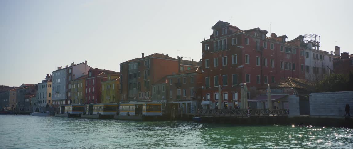 Colorful homes and houseboats along the banks of the Grand Canal in Venice, Italy