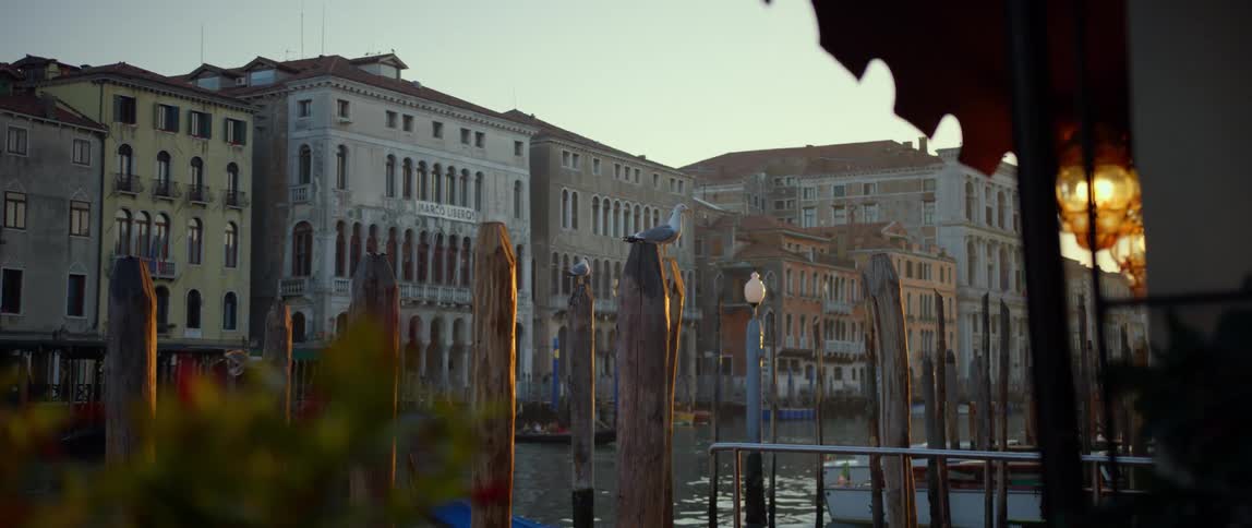 View of palazzos along the Grand Canal in Venice through the gondola docking posts on the opposite bank