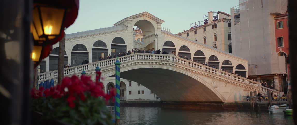 A crowd of tourists standing on the Rialto bridge over the Grand Canal in Venice