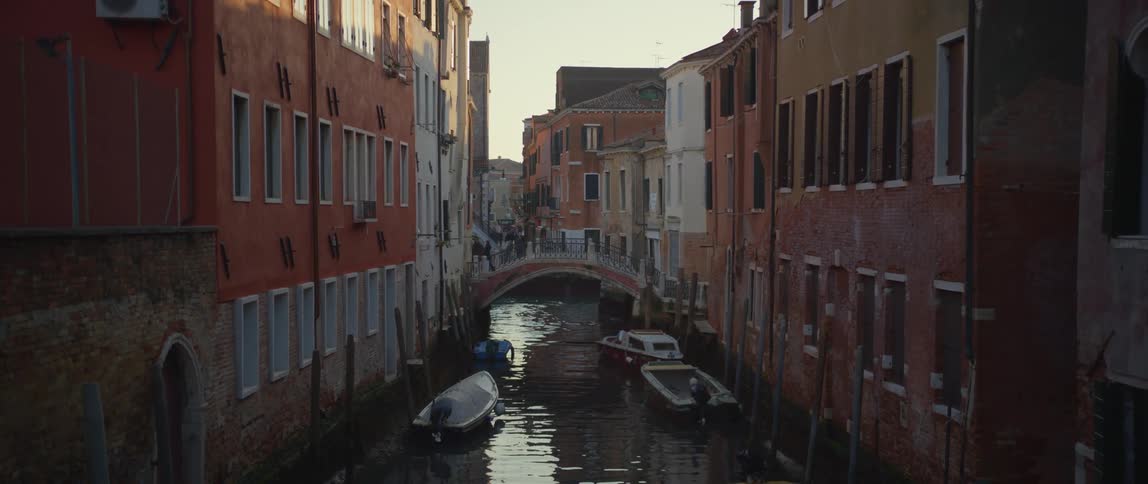 A bridge over a canal in Venice at sunset