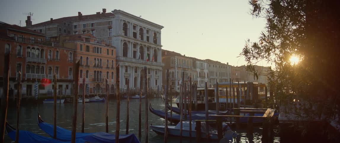 Beautiful sunset view in Venice of Museo di Palazzo Grimani along with other palazzos and gondolas docked along the Grand Canal