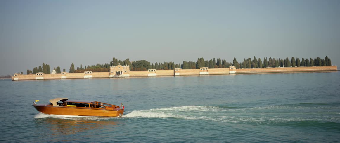 A view of a Venetian water taxi in the channel near San Michele Island cemetary