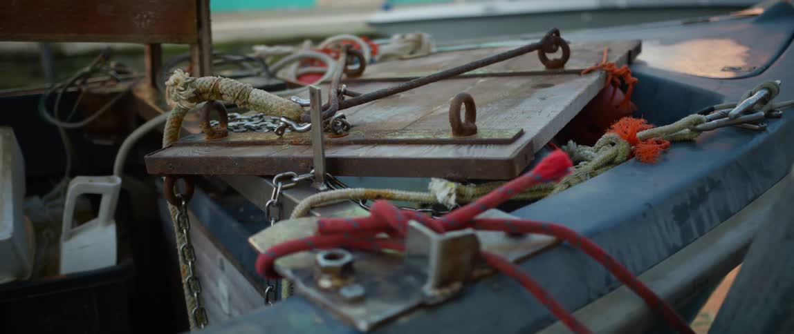 Wood, ropes, and other accoutrements strewn about on a fishing boat on Burano Island, Venice, Italy