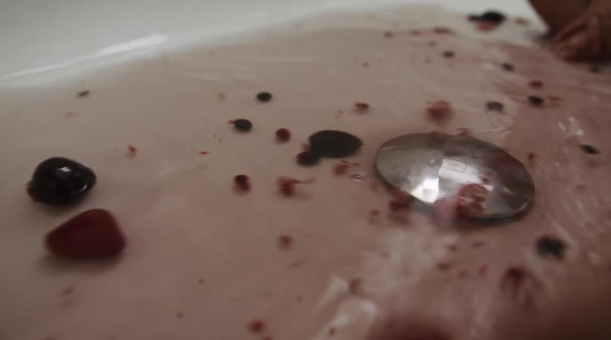 A view of a person putting water down the drain