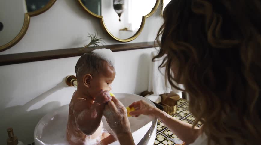 A mother giving her son a bath