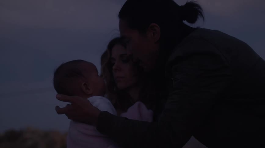 A father kisses his baby on the forehead