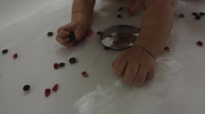 A baby sitting in a sink
