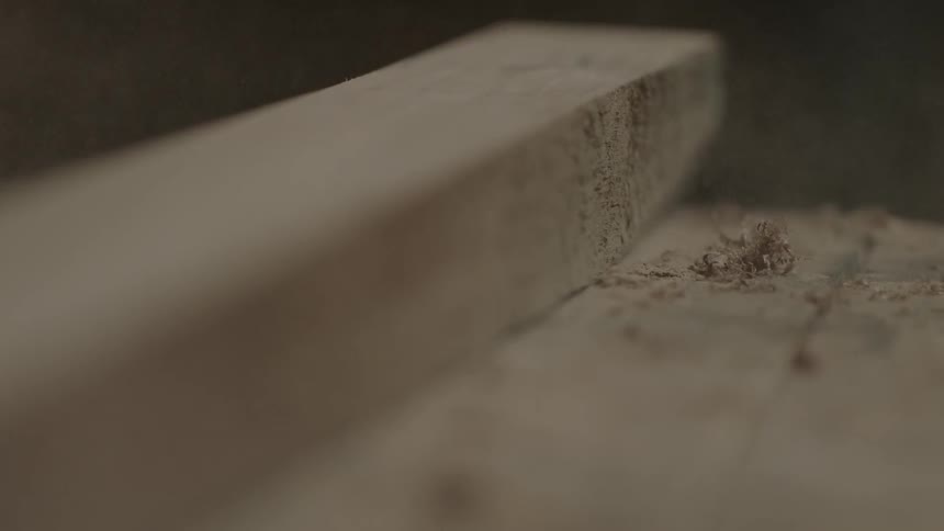 Piece of wood being placed on a work table