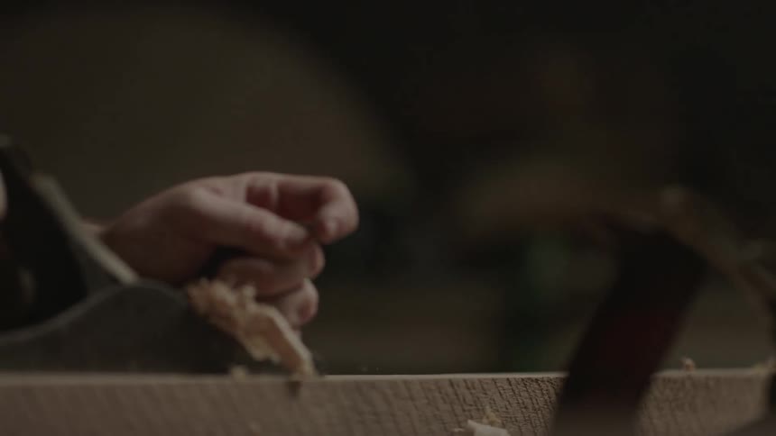 Man sanding a piece of wood