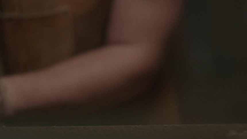 Man using a hand sander on a piece of wood