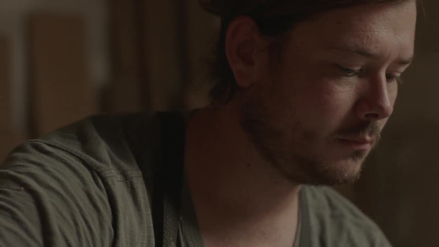 A concentrating man stops and looks to the side