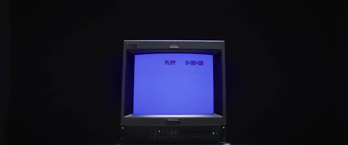 A crt television displaying a blank screen in a dark place