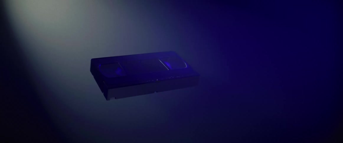 A vhs cassette tape hovers in the air and slowly rotates