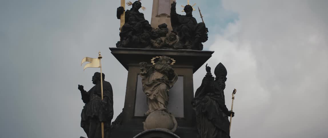 Religous figure sculptures with golden accents on the Column of the Holy Trinity in Mala Strana, Prague, Czech Republic