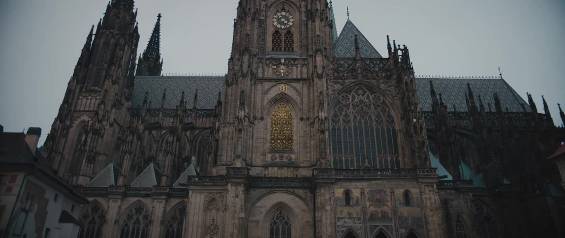 View from below of the gothic facade and clock tower of Saint Vitus Cathedral in Prague Castle Complex, Czech Republic