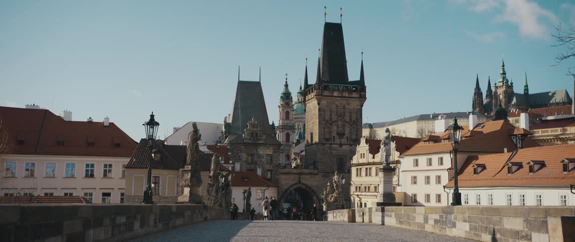 View of the Mala Strana Bridge Tower from Charles Bridge, with Saint Nicholas Church behind, in Prague, Czech Republic.