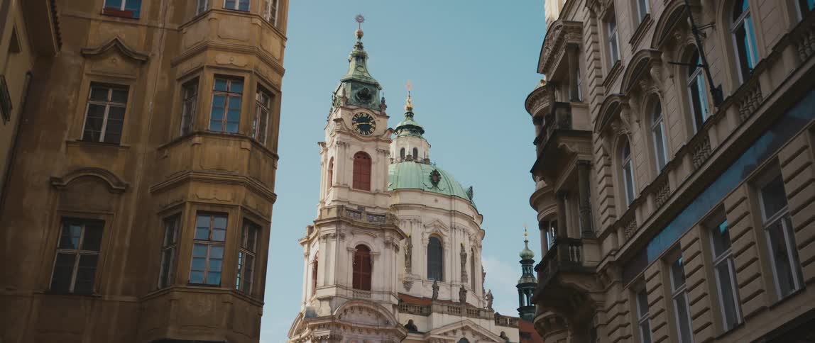 The ornate clock tower, belfry and dome of Saint Nicholas Church in Lesser Town of Prague, Czech Republic