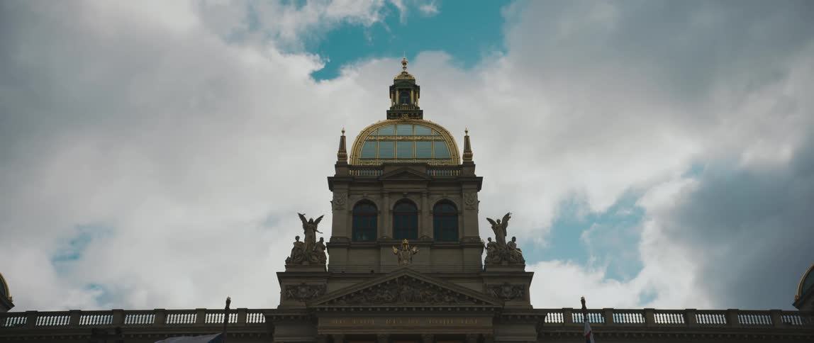An ornate building with statues on a cloudy day