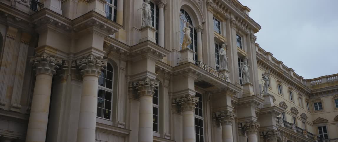 View of the many windows, statues, and ornate columns of the rebuilt Berlin Palace which houses the Humboldt Forum museum