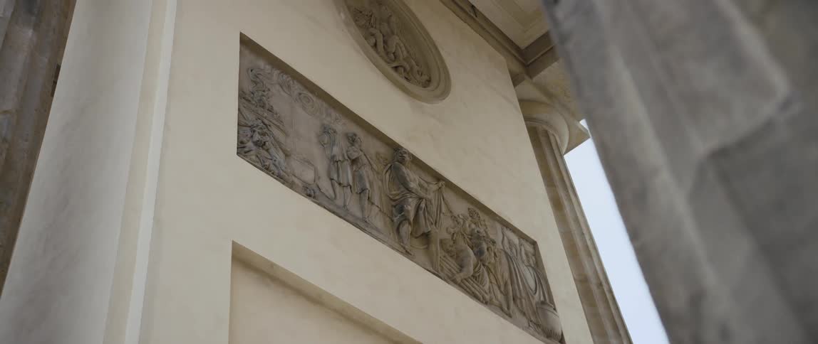 A relief on one of the walls between the columns of the Brandenburg Gate in Berlin, Germany