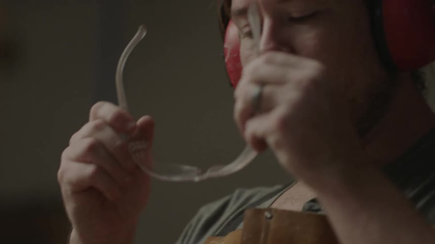 Man putting ear protection on as well as safety glasses